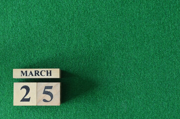 March 25, number cube on snooker table, sport background.