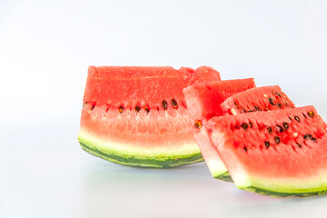 Red ripe watermelon sliced on a white background.