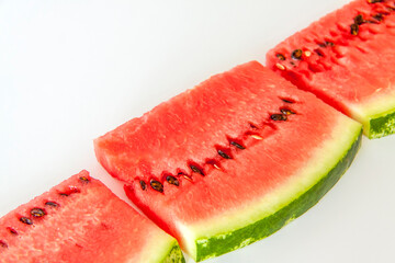 Red ripe watermelon sliced on a white background.