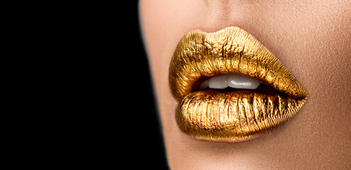 Golden lipstick closeup. Metal gold lips. Beautiful makeup. Sexy lips, bright paint on beautiful model girl's mouth, close-up. Metallic Lipstick closeup. Isolated on black background