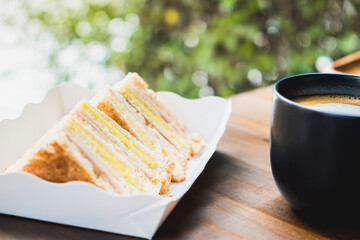 Grilled cheese sandwich with hot latte on wooden table in cafe. Cup of coffee the best start to any morning.