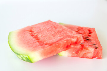 Red ripe watermelon sliced on a white background.