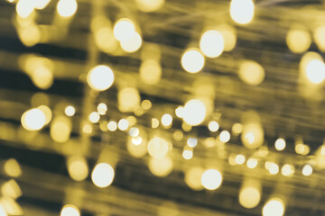 Defocused abstract bokeh circular reflection of Merry Christmas light on gold background. Eve party winter. Happy new year concept.
