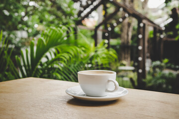 Cup of coffee on brown wooden table at coffee shop. Hot cappuccino the best start to any morning at cafe with copy space.