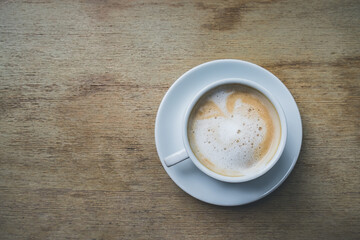 Cup of coffee on brown wooden table at coffee shop. Hot cappuccino the best start to any morning at cafe with copy space. Top view, Top-down