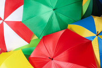 Many bright umbrellas as background, top view