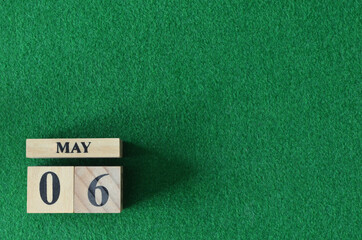 May 6, number cube on snooker table, sport background.