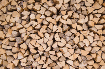 Composition of wood logs for texture, background. Natural wooden logs stacked Stocking up for winter. A pile of cut tree trunks