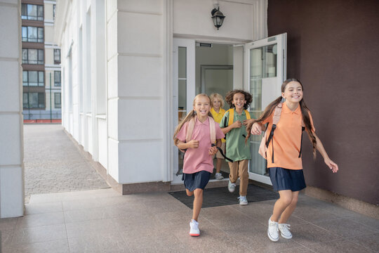 Schoolchildren Running Out Of School After Lessons