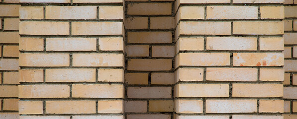 Horizontal detail shot of new brick wall with different depth for background. Beige texture 