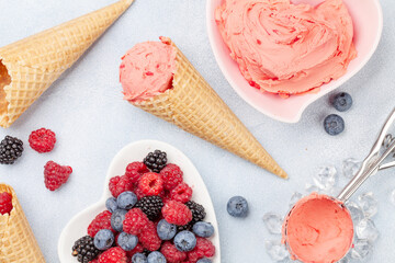 Berry ice cream, waffle cones and fresh berries
