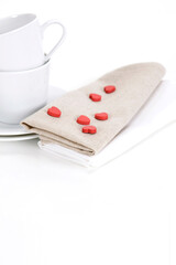 heart shapes on the napkin and pile of coffee cup