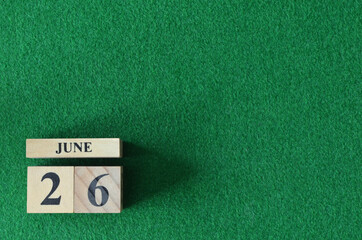 June 26, number cube on snooker table, sport background.