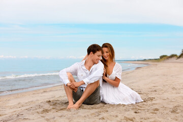 Young married couple relax on the beach