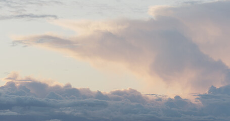 clouds slowly float in the sky during sunset