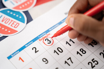 Close up of Hands marking november 3 election day on Calendar as reminder for voting - Concept of reminder for US election.