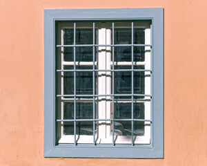 Fototapeta premium vintage window frame with iron railings on colorful wall, Athens Greece, space for text