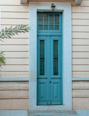Fototapeta na wymiar classic design house entrance green door by the sidewalk, Athens Greece