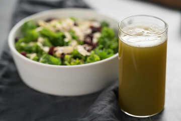 Salad with kale, cranberries and almond flakes in white bowl on linen napkin with copy space