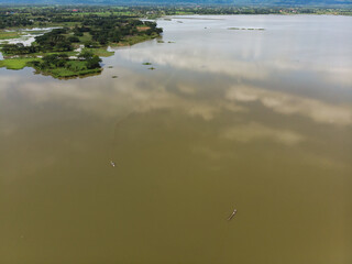Asian fisherman catching fish in natural lake