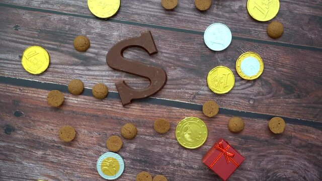 Dutch holiday Sinterklaas background. Rotation children shoe, carrots for Santa's horse, gifts, traditional sweets pepernoten and chocolate letter. Schoentje zetten concept. 4k video