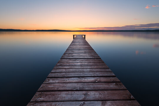 Old wooden pier at sunset. Long exposure, linear perspective
