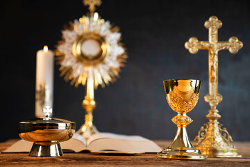 Catholic religion concept. Catholic symbols composition. The Cross, monstrance,  Holy Bible and...