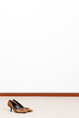 dress shoes and white wall