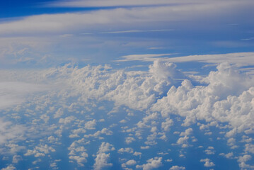 Fototapeta na wymiar Clouds and sky from airplane window view