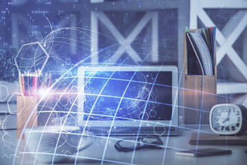Double exposure of desktop with computer and world map hologram. International data network concept.