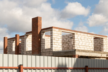 Walls of new house against blue sky