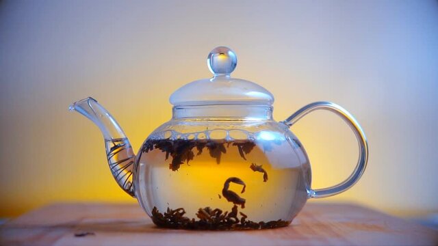 Tea being poured into glass tea cup hd