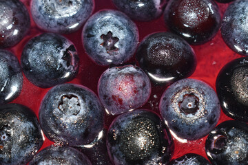 Blueberry jelly in glasses. Pink and blue background from berries. Berry sweet dessert.