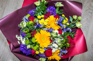 Festive wedding bouquet of different flowers in the package, top view, selective focus, close up