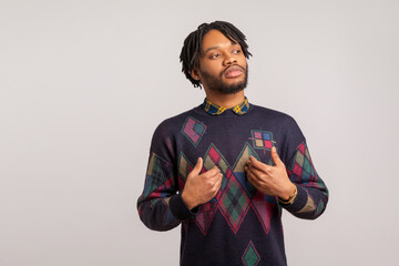 Self confident egoistic guy with dreadlocks pointing hands on himself with arrogant face, proud of...