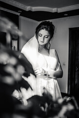 Black and white photo beautiful bride in an elegant dress posing in the room
