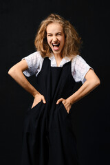 Portrait of screaming girl with hands on her waist