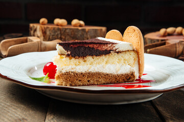 Closeup on tiramisu cake with berry sauce