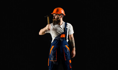 Hammer hammering. Builder in helmet, hammer, handyman, builders in hardhat. Copy space. Bearded...