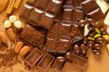 White and milk chocolates. Almond, pistachio, hazelnut.. background, texture..