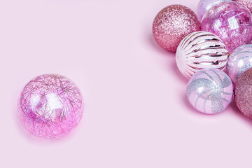Christmas composition. Set of christmas pink decorations, shiny balls on pastel background. Mock up for new year gretting card. Copy space for text or lettering