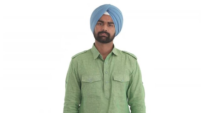 Young beard Indian man shrugging shoulders. I don't know gesture. Isolated on white background.