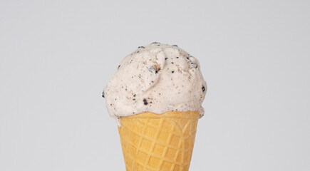Ice cream Cookies & Cream scoop in waffle cone on white background, Front view Food concept.