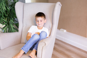 little boy in white t-shirt posing. Portrait of a fashionable male child. The concept of children's style and fashion.