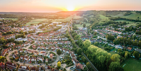 Aerial view of British town set in beautiful countryside in warm light of sunset