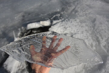 A piece of ice on the hand palm