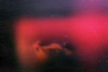 Distressed blurred abstract background dirty bright red, black, spots with a dark frame and with traces of spots and grain, scratches, dirt.