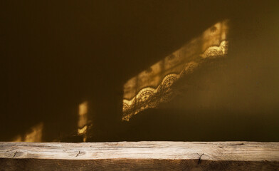 the dark background of the wall on the glare of the glare falling from the window and the shabby...