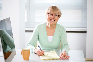 Portrait of mature business woman looking at camera in an office