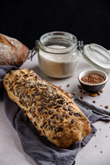 Sourdough artisan bread with pumpkin seeds on a towel. Organic grain wholemeal sourdough bread. 
